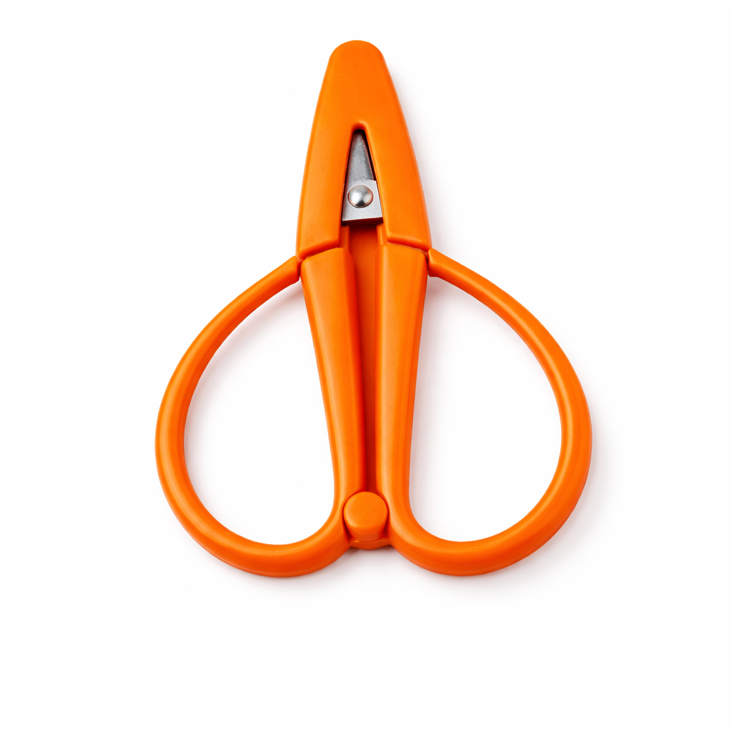 Orange scissors on a white background