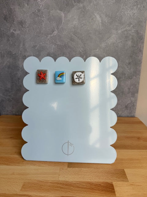 Scalloped metal magnetic board showing needleminders